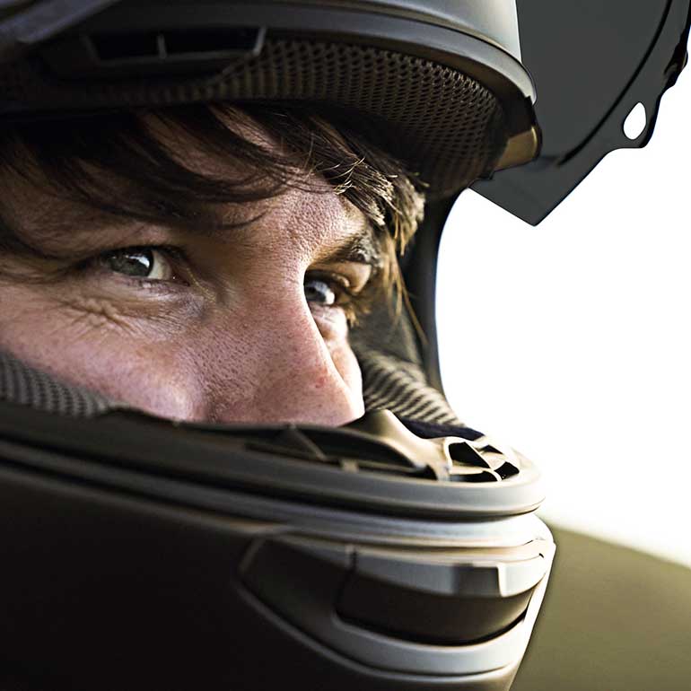 Close up view of male Triumph rider wearing helmet