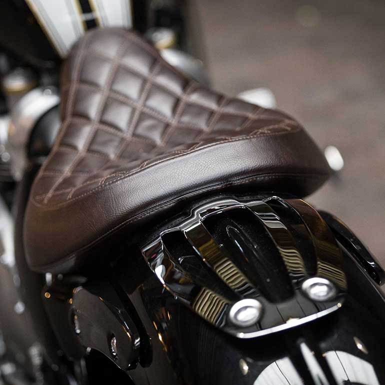 Close up view of Triumph motorcyle brown leather seat